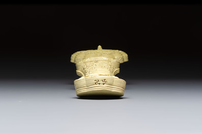 A large Chinese lemon-yellow-glazed biscuit 'Dragons' ruyi in the style of Wang Bingrong, on a wooden stand, Republic