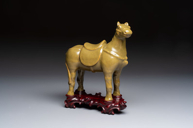 A Chinese teadust-glazed model of a horse on a wooden stand, Republic