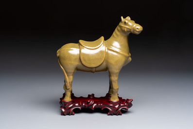 A Chinese teadust-glazed model of a horse on a wooden stand, Republic