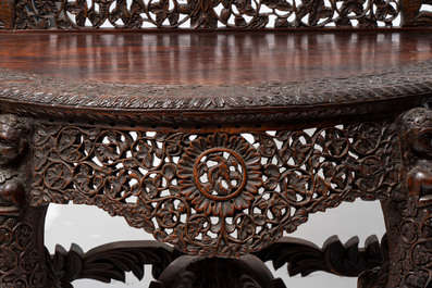 A finely carved Anglo-Indian rosewood demi-lune console table with lions, 19th C.