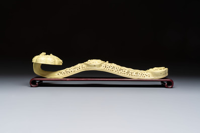 A large Chinese lemon-yellow-glazed biscuit 'Dragons' ruyi in the style of Wang Bingrong, on a wooden stand, Republic