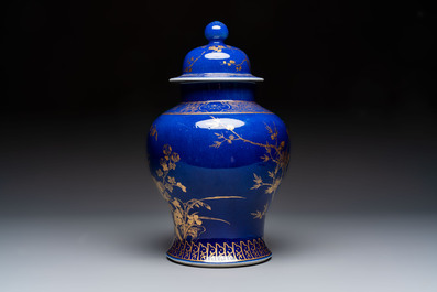 A Chinese gilt-decorated powder-blue-ground vase and cover, Kangxi mark, 19th C.