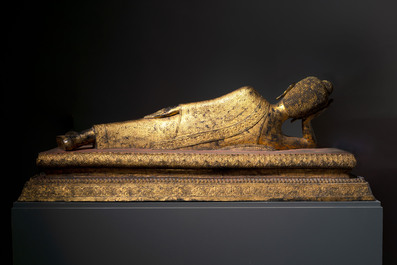 An exceptional and large Thai gilt-bronze figure of Buddha in Parinirvana, 18th C.