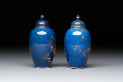 A pair of Chinese gilt-decorated powder-blue-ground miniature vases and wooden covers, 18th C.