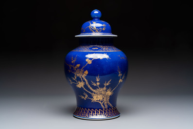 A Chinese gilt-decorated powder-blue-ground vase and cover, Kangxi mark, 19th C.