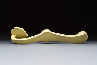 A large Chinese lemon-yellow-glazed biscuit 'Dragons' ruyi in the style of Wang Bingrong, on a wooden stand, Republic
