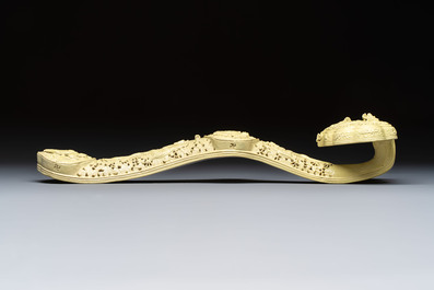 A large Chinese lemon-yellow-glazed biscuit 'Dragons' ruyi in the style of Wang Bingrong, on a wooden stand, Republic