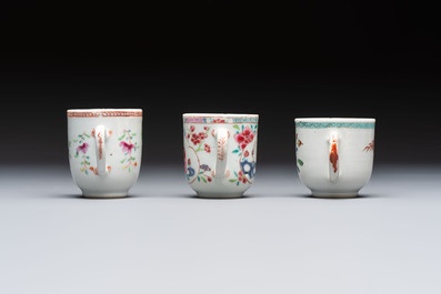 A Chinese famille rose teapot and cover with floral design and three cups, Qianlong