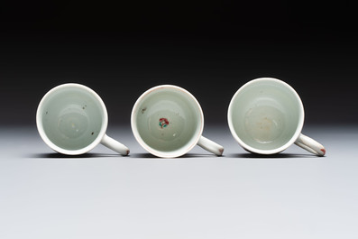 A Chinese famille rose teapot and cover with floral design and three cups, Qianlong