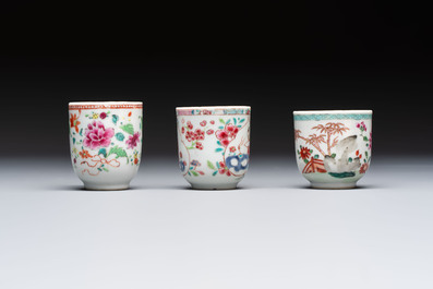 A Chinese famille rose teapot and cover with floral design and three cups, Qianlong