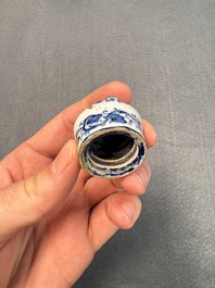 A pair of blue and white Dutch Delft square tea caddies and covers, 18th C.