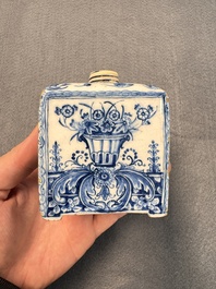 A pair of blue and white Dutch Delft square tea caddies and covers, 18th C.