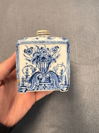 A pair of blue and white Dutch Delft square tea caddies and covers, 18th C.