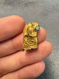 A rare Chinese turquoise- and glass-inlaid gold fitting in the form of a parrot, Han