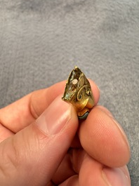 A rare Chinese turquoise- and glass-inlaid gold fitting in the form of a parrot, Han