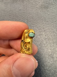 A rare Chinese turquoise- and glass-inlaid gold fitting in the form of a parrot, Han