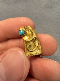 A rare Chinese turquoise- and glass-inlaid gold fitting in the form of a parrot, Han
