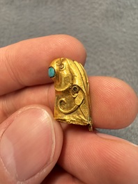 A rare Chinese turquoise- and glass-inlaid gold fitting in the form of a parrot, Han