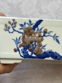 A Chinese blue, white and copper-red rectangular jardini&egrave;re with birds among flowering branches, 20th C.