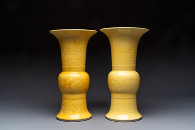 A pair of Chinese yellow-glazed 'Gu' vases with incised chilongs and landscapes, Chenghua mark, 20th C.