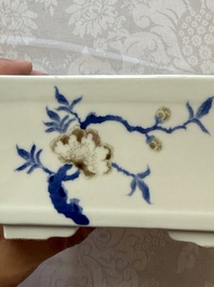 A Chinese blue, white and copper-red rectangular jardini&egrave;re with birds among flowering branches, 20th C.