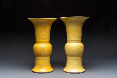 A pair of Chinese yellow-glazed 'Gu' vases with incised chilongs and landscapes, Chenghua mark, 20th C.