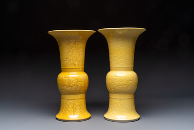 A pair of Chinese yellow-glazed 'Gu' vases with incised chilongs and landscapes, Chenghua mark, 20th C.