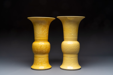 A pair of Chinese yellow-glazed 'Gu' vases with incised chilongs and landscapes, Chenghua mark, 20th C.
