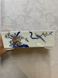 A Chinese blue, white and copper-red rectangular jardini&egrave;re with birds among flowering branches, 20th C.