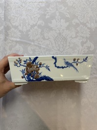 A Chinese blue, white and copper-red rectangular jardini&egrave;re with birds among flowering branches, 20th C.