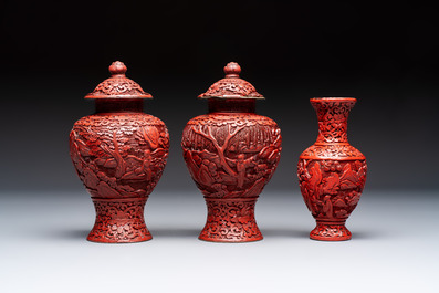 A Chinese cinnabar lacquer plaque, a vase, and a pair of covered vases, 19/20th C.