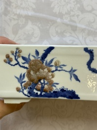 A Chinese blue, white and copper-red rectangular jardini&egrave;re with birds among flowering branches, 20th C.