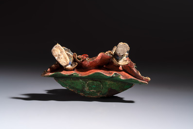 A Chinese gilt and polychrome lacquered papier-m&acirc;ch&eacute; and wooden Guandi on a wooden stand, 19th C.