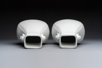 A pair of Chinese white-glazed 'Hu' vases and a Longquan celadon 'Twin Fish' plate, 20th C.