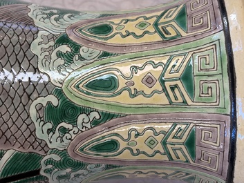 A Chinese verte biscuit 'Dragon Gate Carp 鯉躍龍門' vase on a wooden stand, Xuande mark, 19th C.