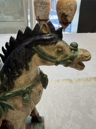 A pair of Chinese sancai-glazed 'Horseriders' roof tiles on wooden stands, Ming