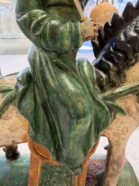 A pair of Chinese sancai-glazed 'Horseriders' roof tiles on wooden stands, Ming