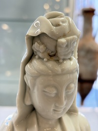 A pair of Chinese Dehua blanc de Chine groups of Guanyin with a child and servants, 18th C.