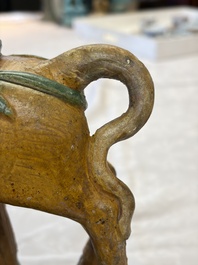 A pair of Chinese sancai-glazed 'Horseriders' roof tiles on wooden stands, Ming