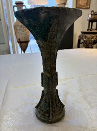 A Chinese archaic bronze wine vessel with Taotie design, Gu 觚, Shang