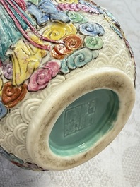 A pair of Chinese famille rose relief-moulded 'Immortals' vases, Qianlong mark, Republic