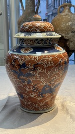A Chinese blue, white and iron-red decorated 'Mythical Animals' vase and cover, 19th C.