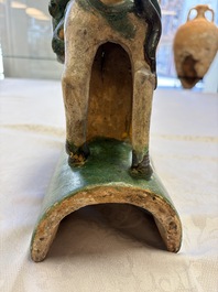 A pair of Chinese sancai-glazed 'Horseriders' roof tiles on wooden stands, Ming