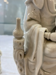 A pair of Chinese Dehua blanc de Chine groups of Guanyin with a child and servants, 18th C.