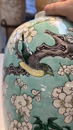 A pair of fine Chinese famille verte turquoise-ground 'Magpie and Prunus' jars with reticulated wooden covers, 19th C.