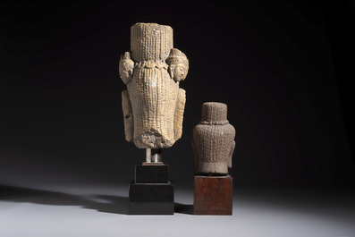 A Khmer-style carved stone head and a carved stone head of a deity, Thailand and Cambodia, 20th C. or earlier