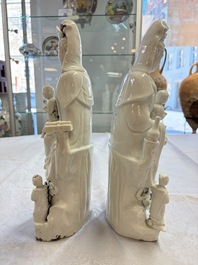 A pair of Chinese Dehua blanc de Chine groups of Guanyin with a child and servants, 18th C.