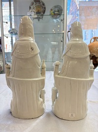 A pair of Chinese Dehua blanc de Chine groups of Guanyin with a child and servants, 18th C.