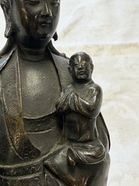 A Chinese bronze standing Guanyin with boy, Ming
