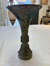 A Chinese archaic bronze wine vessel with Taotie design, Gu 觚, Shang